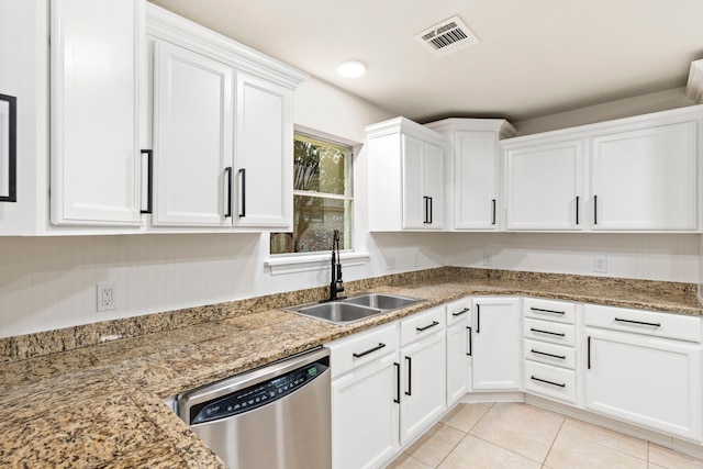 12135 Quail Creek Dr, Houston, TX 77070 - kitchen featuring stainless steel dishwasher, white cabinets, light tile patterned floors, and light stone counters
