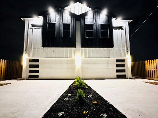 5042 Pershing St Unit Ab, Houston, TX 77033 - view of front of house with concrete driveway, a garage, and board and batten siding