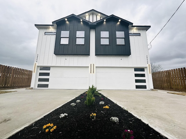 5042 Pershing St Unit Ab, Houston, TX 77033 - modern farmhouse style home with an attached garage, driveway, and board and batten siding