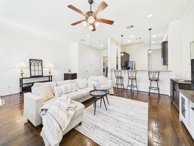 22 Tassia Ln, Pasadena, TX 77058 - living room with a ceiling fan, washer / dryer, dark wood finished floors, recessed lighting, and crown molding