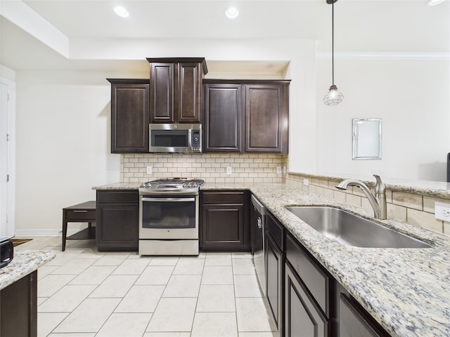 22 Tassia Ln, Pasadena, TX 77058 - kitchen featuring stainless steel appliances, decorative backsplash, light stone counters, dark brown cabinets, and recessed lighting