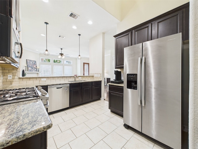 22 Tassia Ln, Pasadena, TX 77058 - kitchen with appliances with stainless steel finishes, backsplash, ceiling fan, light tile patterned floors, and dark brown cabinets