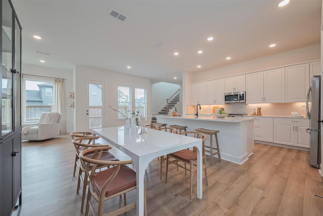 16819 Chapel Knox Dr, Humble, TX 77346 - dining room with light wood finished floors, recessed lighting, and stairs