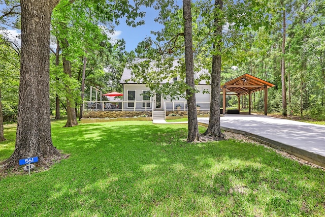 561 N Royale Greens Dr, Coldspring, TX 77331 - view of green lawn with concrete driveway
