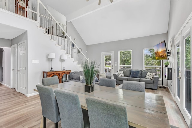 561 N Royale Greens Dr, Coldspring, TX 77331 - dining space with high vaulted ceiling, stairway, and light wood-type flooring
