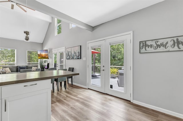 561 N Royale Greens Dr, Coldspring, TX 77331 - kitchen with french doors, wooden counters, light wood-style flooring, white cabinetry, and beam ceiling