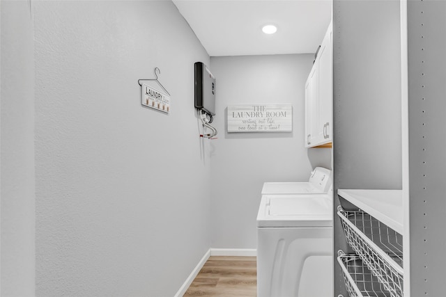 561 N Royale Greens Dr, Coldspring, TX 77331 - laundry room with cabinet space, independent washer and dryer, and light wood-style flooring