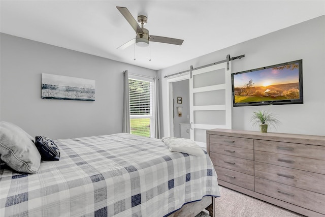 561 N Royale Greens Dr, Coldspring, TX 77331 - bedroom featuring a barn door, carpet, and ceiling fan