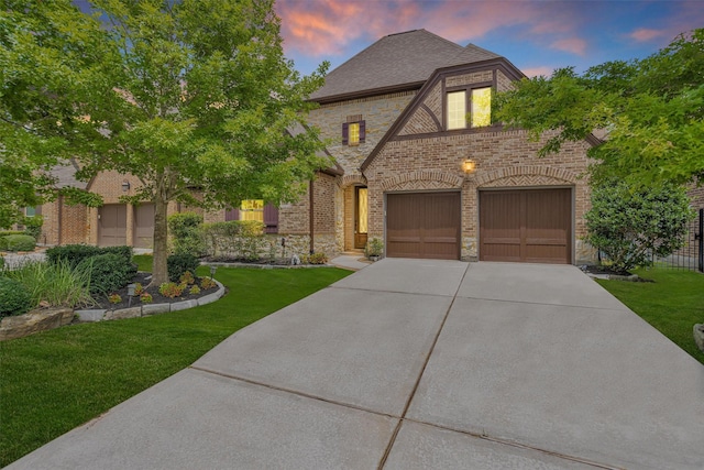 54 N Lochwood Way, Tomball, TX 77375 - view of front of home featuring stone siding, concrete driveway, brick siding, and a front yard