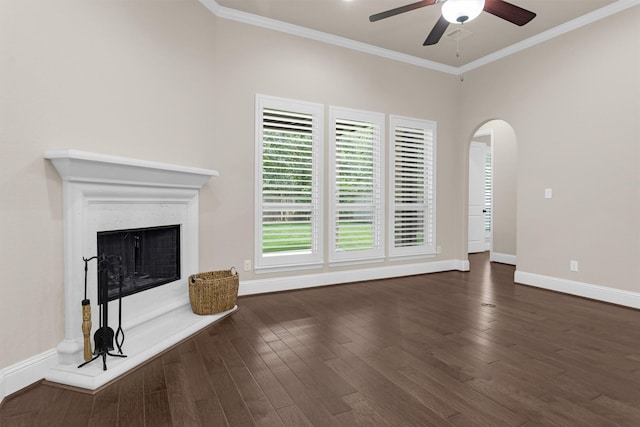 54 N Lochwood Way, Tomball, TX 77375 - unfurnished living room with a ceiling fan, crown molding, arched walkways, dark wood-style floors, and a fireplace with raised hearth