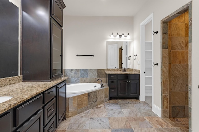 54 N Lochwood Way, Tomball, TX 77375 - bathroom featuring a garden tub, two vanities, and a walk in closet