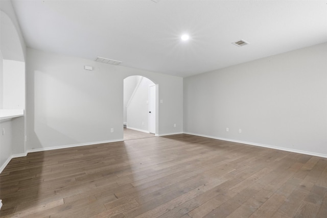 9987 Sterling Place Dr, Conroe, TX 77303 - unfurnished room with arched walkways and hardwood / wood-style floors