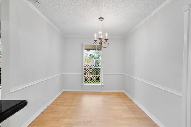 2800 Jeanetta St Unit 2502, Houston, TX 77063 - unfurnished dining area featuring light wood finished floors, a textured ceiling, a chandelier, and ornamental molding