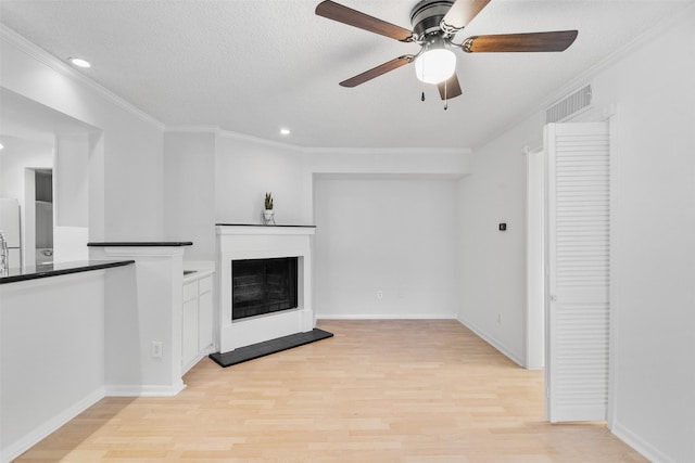 2800 Jeanetta St Unit 2502, Houston, TX 77063 - unfurnished living room with crown molding, ceiling fan, light wood finished floors, a fireplace with raised hearth, and recessed lighting