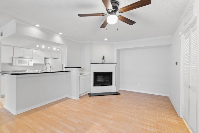 2800 Jeanetta St Unit 2502, Houston, TX 77063 - unfurnished living room featuring light wood finished floors, ceiling fan, recessed lighting, crown molding, and a fireplace with raised hearth