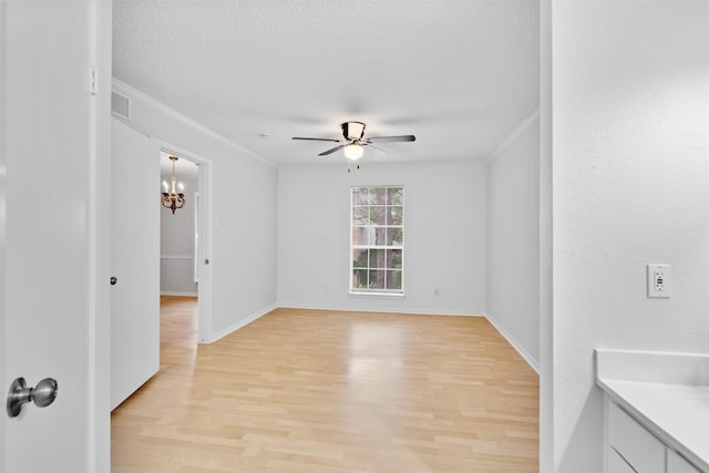 2800 Jeanetta St Unit 2502, Houston, TX 77063 - empty room with light wood-style floors, ceiling fan, a chandelier, crown molding, and a textured ceiling