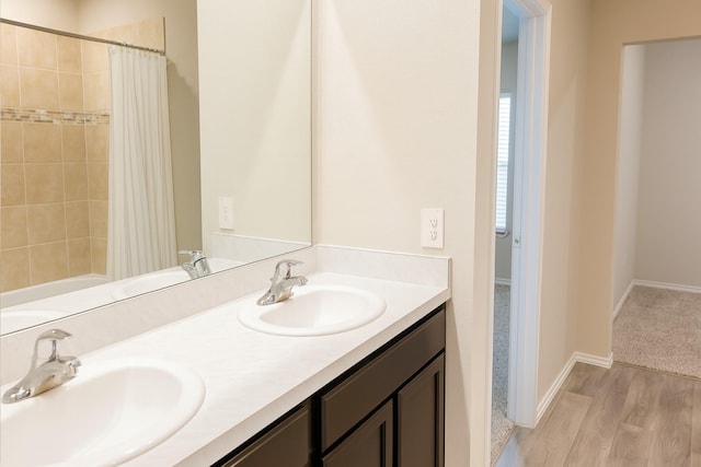 40607 Creekside Bluff Trl, Magnolia, TX 77354 - bathroom with double vanity, wood finished floors, and shower / bath combo