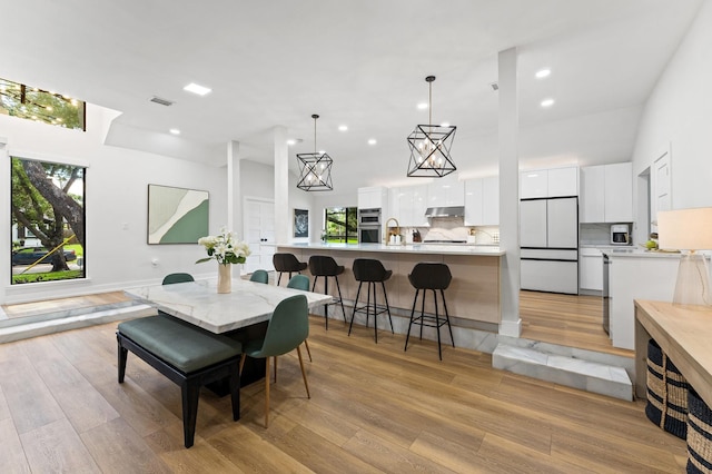 10826 Moonlight Dr, Houston, TX 77096 - dining area featuring light wood-type flooring, plenty of natural light, and recessed lighting