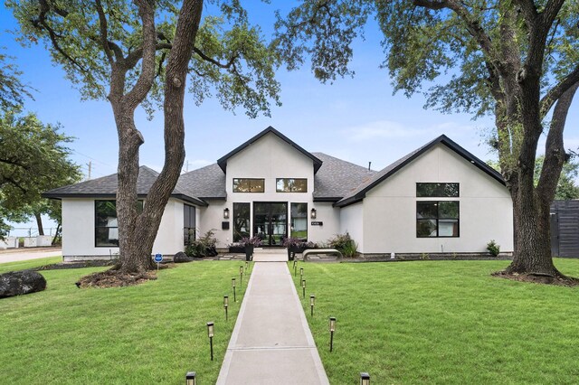 10826 Moonlight Dr, Houston, TX 77096 - view of front facade featuring stucco siding, roof with shingles, and a front yard