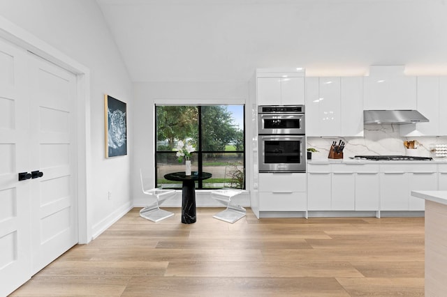 10826 Moonlight Dr, Houston, TX 77096 - kitchen featuring modern cabinets, extractor fan, light countertops, stainless steel appliances, and white cabinets