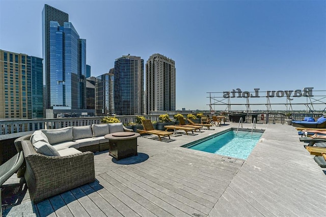 915 Franklin St Unit 2I, Houston, TX 77002 - community pool with a wooden deck, outdoor lounge area, and a city view
