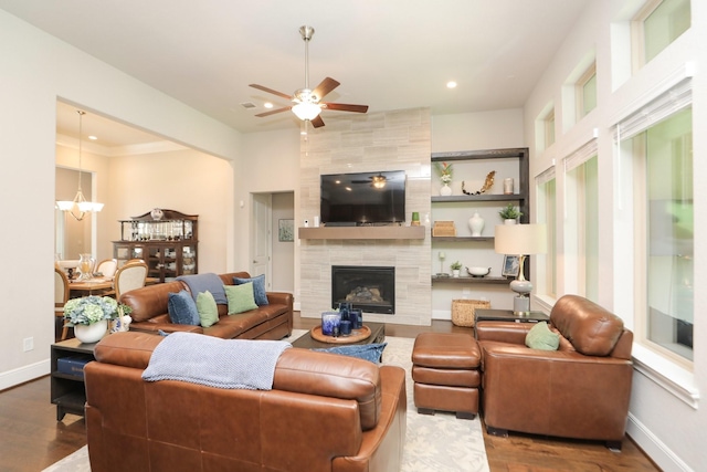 8511 Tynan Ridge Dr, Magnolia, TX 77354 - living area with wood finished floors, ceiling fan, recessed lighting, a tile fireplace, and a chandelier