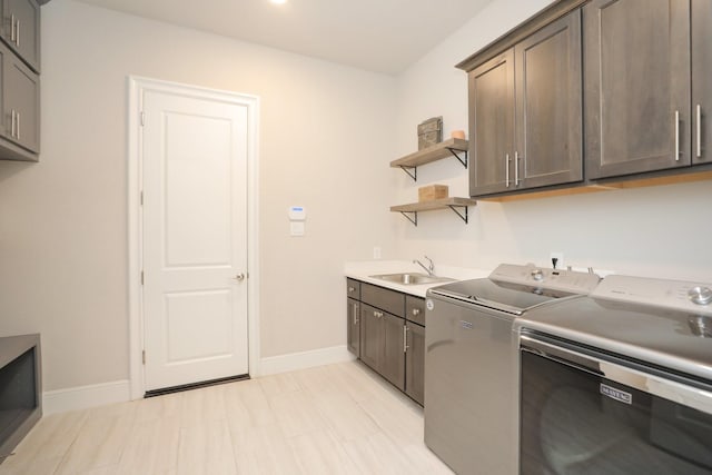 8511 Tynan Ridge Dr, Magnolia, TX 77354 - laundry area with washing machine and clothes dryer and cabinet space