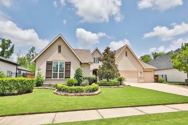 8511 Tynan Ridge Dr, Magnolia, TX 77354 - view of front facade with stucco siding, concrete driveway, and an attached garage