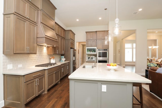 8511 Tynan Ridge Dr, Magnolia, TX 77354 - kitchen featuring stainless steel appliances, a breakfast bar area, decorative backsplash, dark wood-type flooring, and light countertops