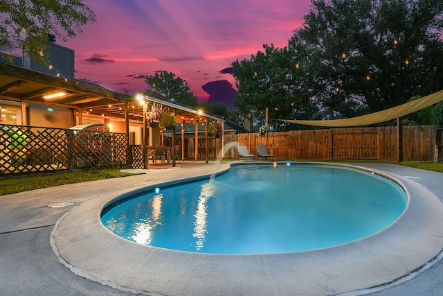12223 Paddock Way, Houston, TX 77065 - pool at dusk featuring a fenced backyard and a patio