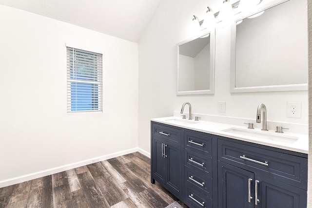 12223 Paddock Way, Houston, TX 77065 - bathroom featuring lofted ceiling, double vanity, and wood finished floors