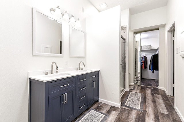 12223 Paddock Way, Houston, TX 77065 - full bath with wood finished floors, a stall shower, double vanity, and a walk in closet