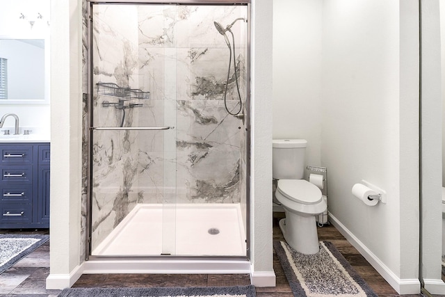 12223 Paddock Way, Houston, TX 77065 - bathroom with a marble finish shower, vanity, and wood finished floors