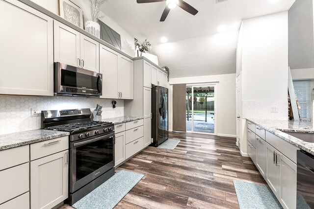 12223 Paddock Way, Houston, TX 77065 - kitchen with stainless steel appliances, ceiling fan, backsplash, vaulted ceiling, and dark wood-style flooring