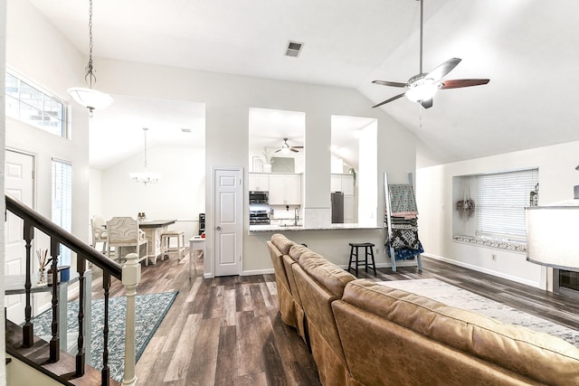 12223 Paddock Way, Houston, TX 77065 - living area featuring ceiling fan, dark wood-style floors, a chandelier, high vaulted ceiling, and stairs