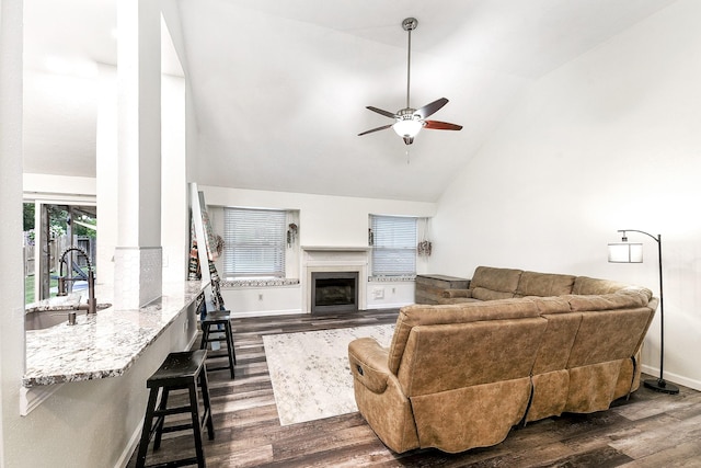12223 Paddock Way, Houston, TX 77065 - living room with dark wood-style flooring, a ceiling fan, a glass covered fireplace, and high vaulted ceiling
