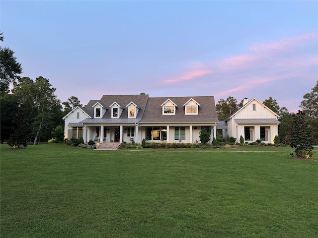 37732 Marias Way, Magnolia, TX 77354 - view of front of house with a standing seam roof, covered porch, board and batten siding, a front yard, and a metal roof