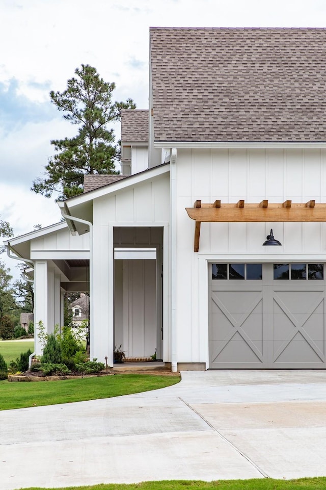 37732 Marias Way, Magnolia, TX 77354 - view of front of home with roof with shingles, board and batten siding, and concrete driveway