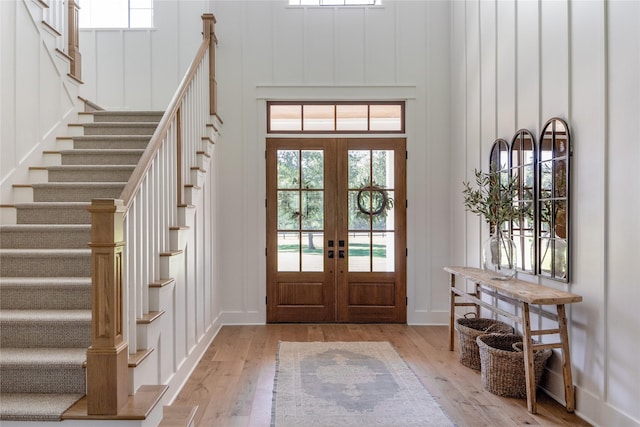 37732 Marias Way, Magnolia, TX 77354 - entrance foyer featuring french doors, stairs, hardwood / wood-style flooring, and a decorative wall