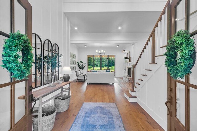 37732 Marias Way, Magnolia, TX 77354 - entryway with light wood-style flooring, stairway, a chandelier, and recessed lighting