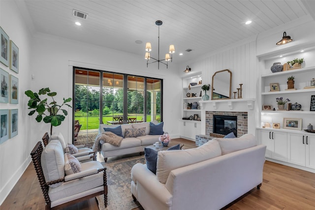 37732 Marias Way, Magnolia, TX 77354 - living area with built in shelves, wooden ceiling, a fireplace, light wood-style floors, and a chandelier