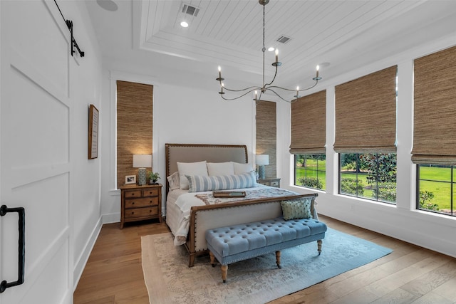 37732 Marias Way, Magnolia, TX 77354 - bedroom with a tray ceiling, hardwood / wood-style flooring, recessed lighting, wood ceiling, and a chandelier