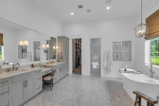 37732 Marias Way, Magnolia, TX 77354 - bathroom featuring vanity, a stall shower, a soaking tub, a chandelier, and a walk in closet