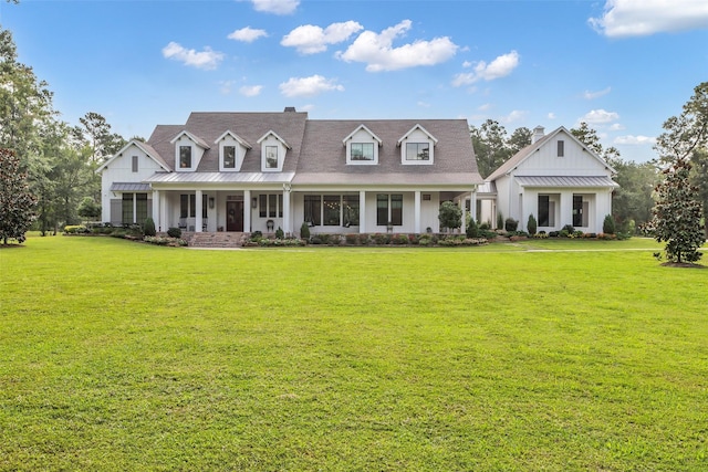 37732 Marias Way, Magnolia, TX 77354 - view of front of property with board and batten siding, a front lawn, covered porch, a chimney, and a standing seam roof