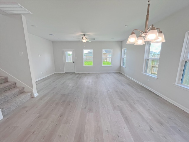32402 Fly Fish Way, Fulshear, TX 77441 - unfurnished living room featuring light wood finished floors, a ceiling fan, and stairway