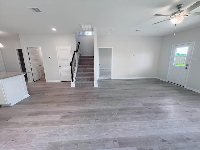 32402 Fly Fish Way, Fulshear, TX 77441 - unfurnished living room featuring stairway, a ceiling fan, light wood finished floors, and recessed lighting