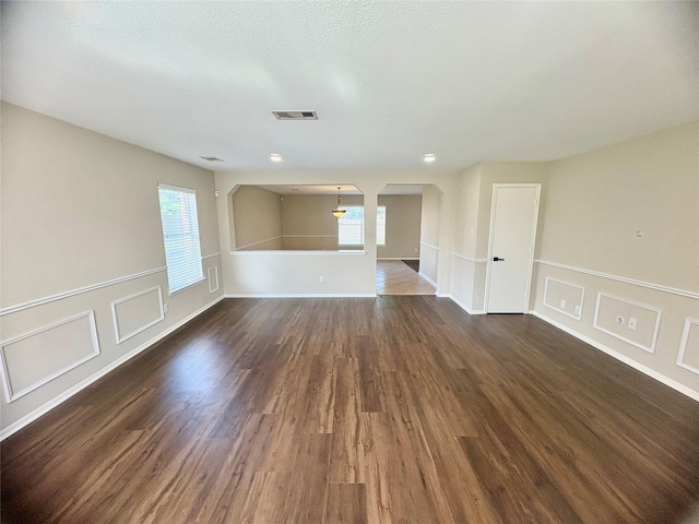3403 Fox Ct, Pearland, TX 77581 - spare room featuring dark wood-type flooring and arched walkways