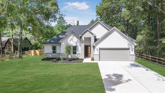 8703 Miller Rd, Magnolia, TX 77354 - view of front facade featuring stone siding, a garage, concrete driveway, stucco siding, and a shingled roof