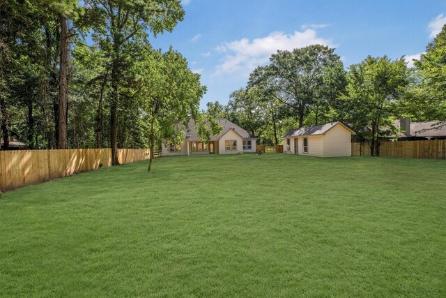 8703 Miller Rd, Magnolia, TX 77354 - fenced backyard with an outbuilding