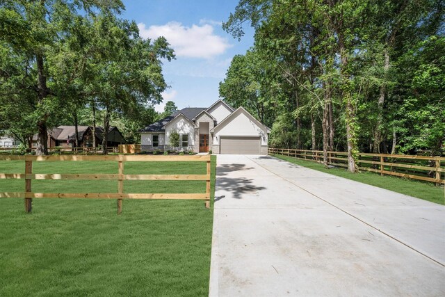 8703 Miller Rd, Magnolia, TX 77354 - view of front facade with driveway and an attached garage